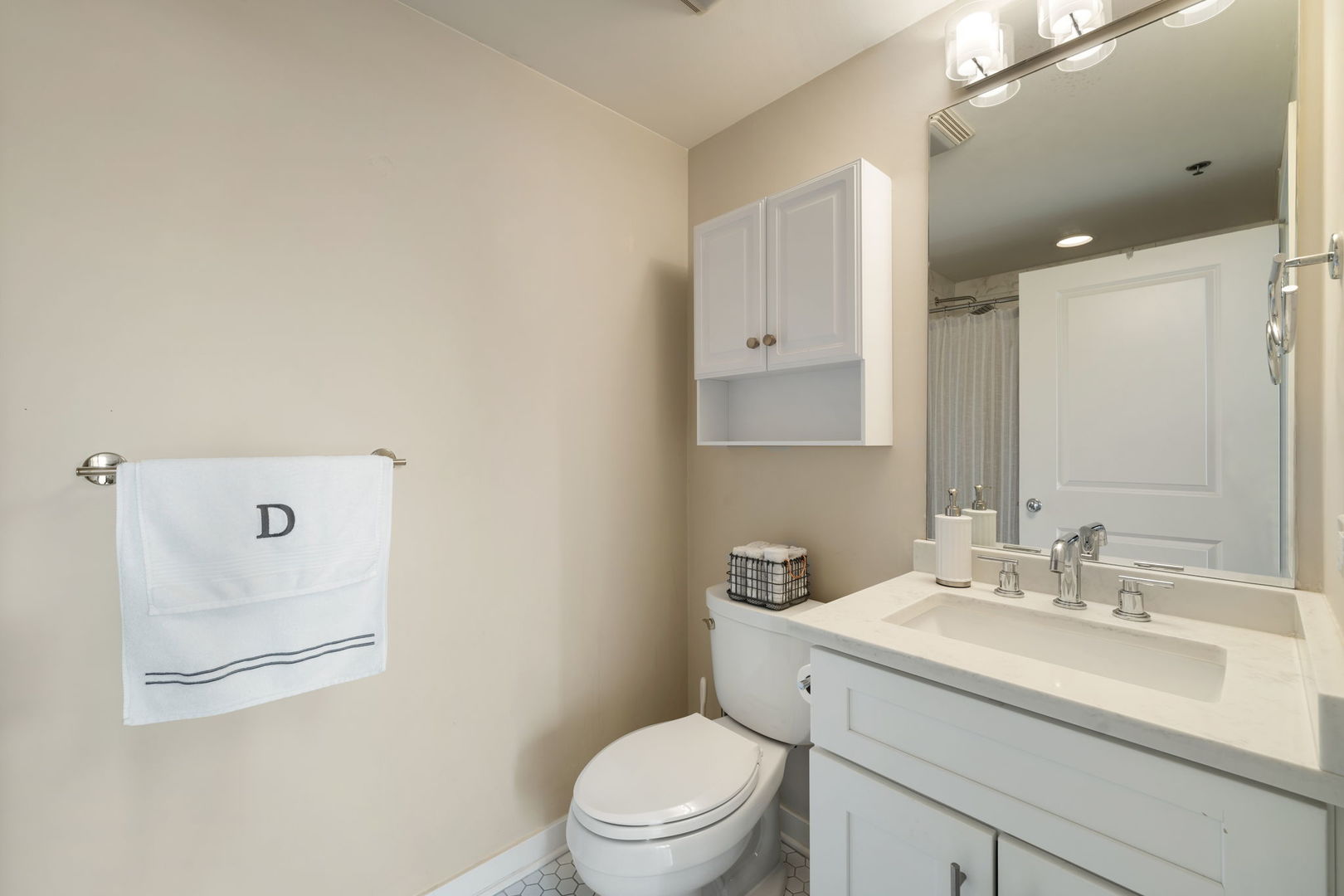 50 East 16th Street, Unit 1405 Chicago, IL 60616 - Photo 27 of 36 a bathroom with a toilet sink vanity and mirror