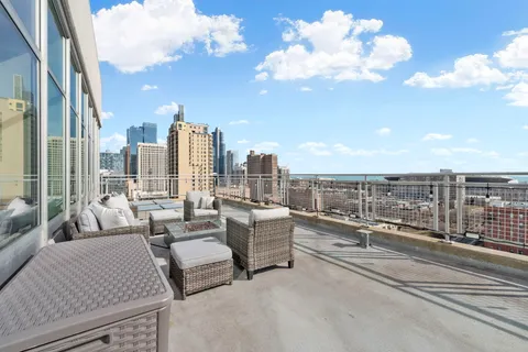 a view of roof deck with patio