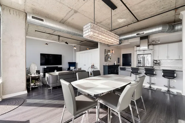 a view of a dining room with furniture wooden floor and chandelier