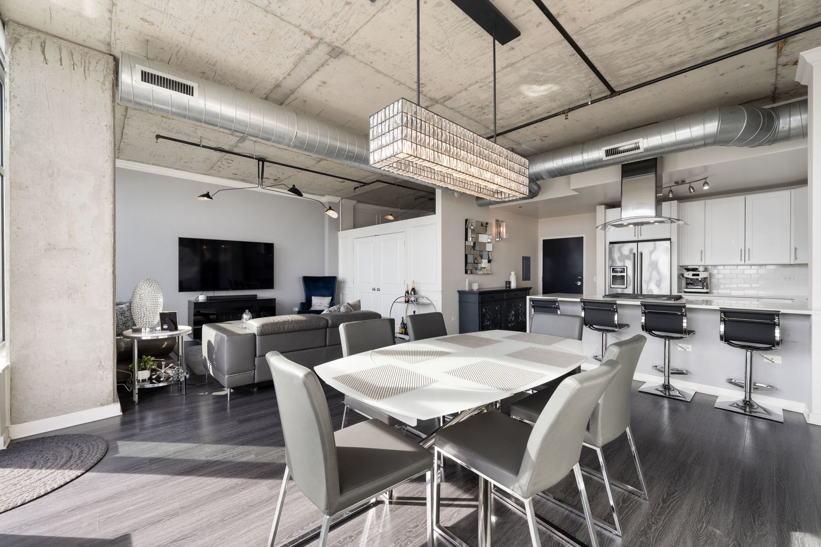 50 East 16th Street, Unit 1405 Chicago, IL 60616 - Photo 4 of 36 a view of a dining room with furniture wooden floor and chandelier