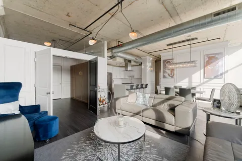 a living room with furniture a rug and a large window