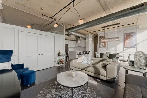 a living room with furniture a rug and white walls