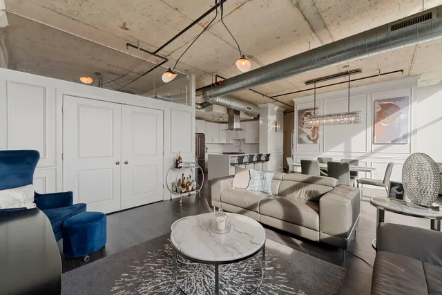a living room with furniture a rug and white walls