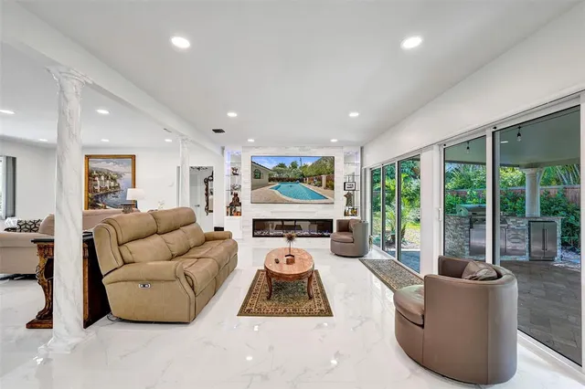 a large kitchen with stainless steel appliances granite countertop a lot of counter space a sink and dishwasher a stove top oven with wooden floor