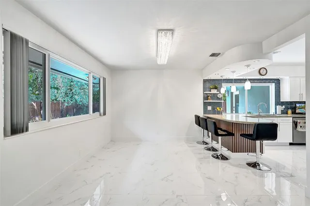 a kitchen with a sink and a large window