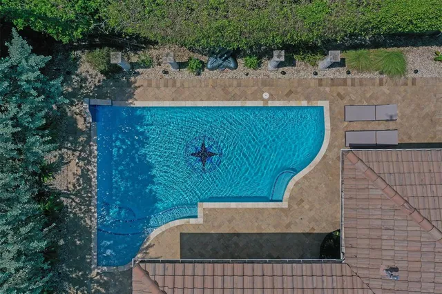 a view of a hallway with wooden floor and a living room