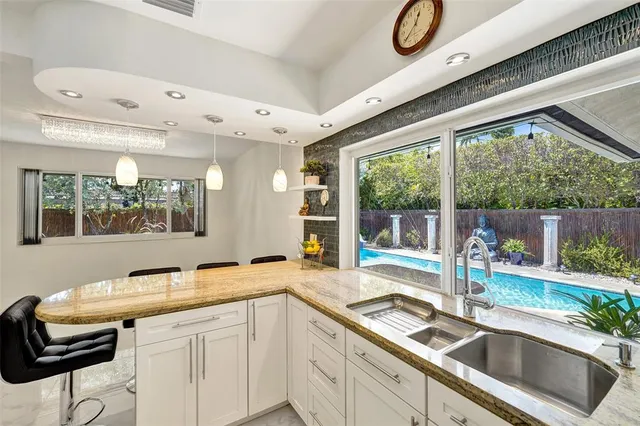 a view of a backyard with table and chairs and wooden fence