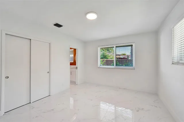 front view of a house with a yard and potted plants
