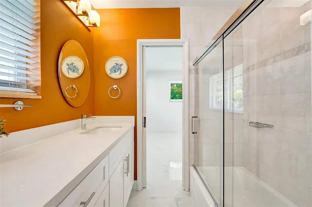 a front view of a house with a yard and potted plants