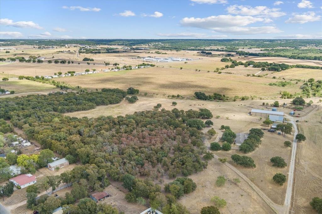 410 State School Road Gatesville, TX 76528 - Photo 20 of 39 Expansive acreage featuring mixed terrain, a clustered tree line, and an outbuilding structure