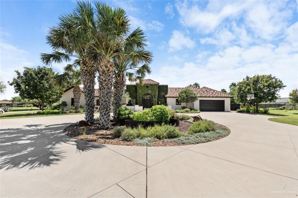 1421 Encanto Road, Unit SERVICE Weslaco, TX 78596 - Photo 2 of 37 a front view of a house with garden
