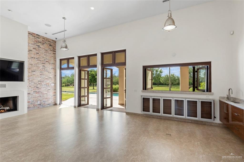 1421 Encanto Road, Unit SERVICE Weslaco, TX 78596 - Photo 33 of 37 a view of a livingroom with furniture wooden floor fire place and windows