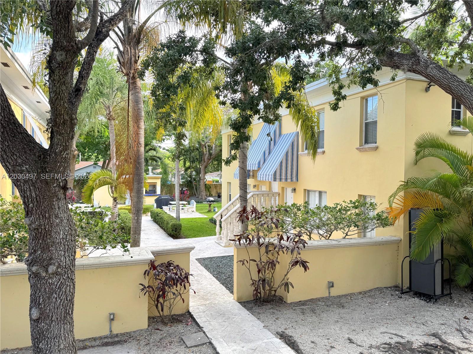 3375 Franklin Avenue, Unit D Miami, FL 33133 - Photo 28 of 29 a view of a house with a tree in front of it