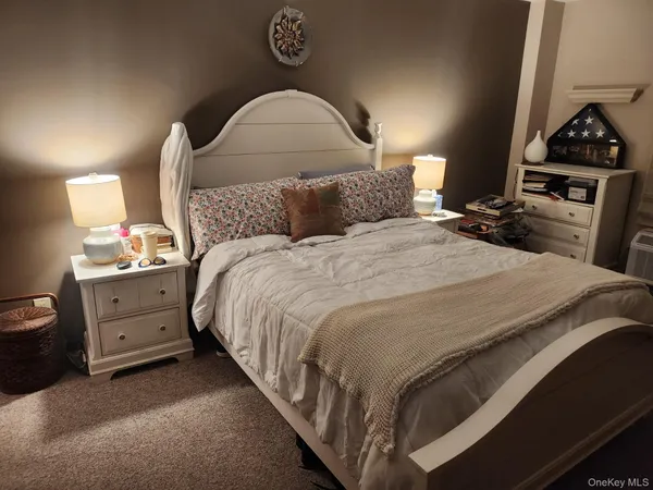 a bed room with a bed and a lamp