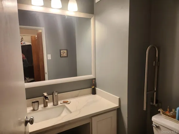 a bathroom with a sink vanity and a mirror