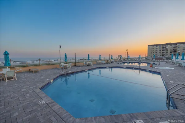 a view of a swimming pool and an outdoor seating