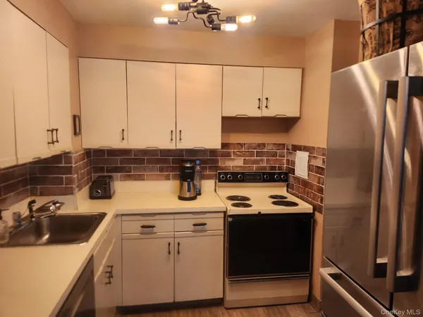 a kitchen with a sink a stove and cabinets