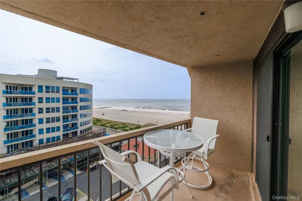 a balcony with table and chairs