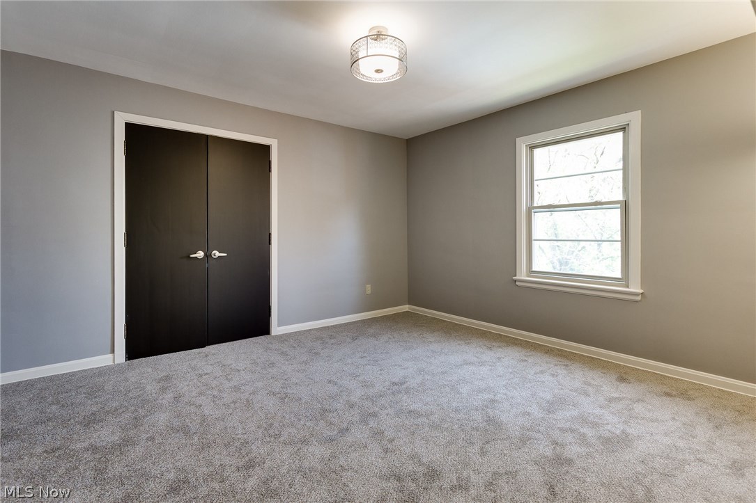 1046 Allston Road Cleveland Heights, OH 44121 - Photo 29 of 34 The 12 x 16 Master bedroom has new plush carpeting. There are two windows for plenty of natural light, and two custom wall light fixtures. the double doors lead into the closet.