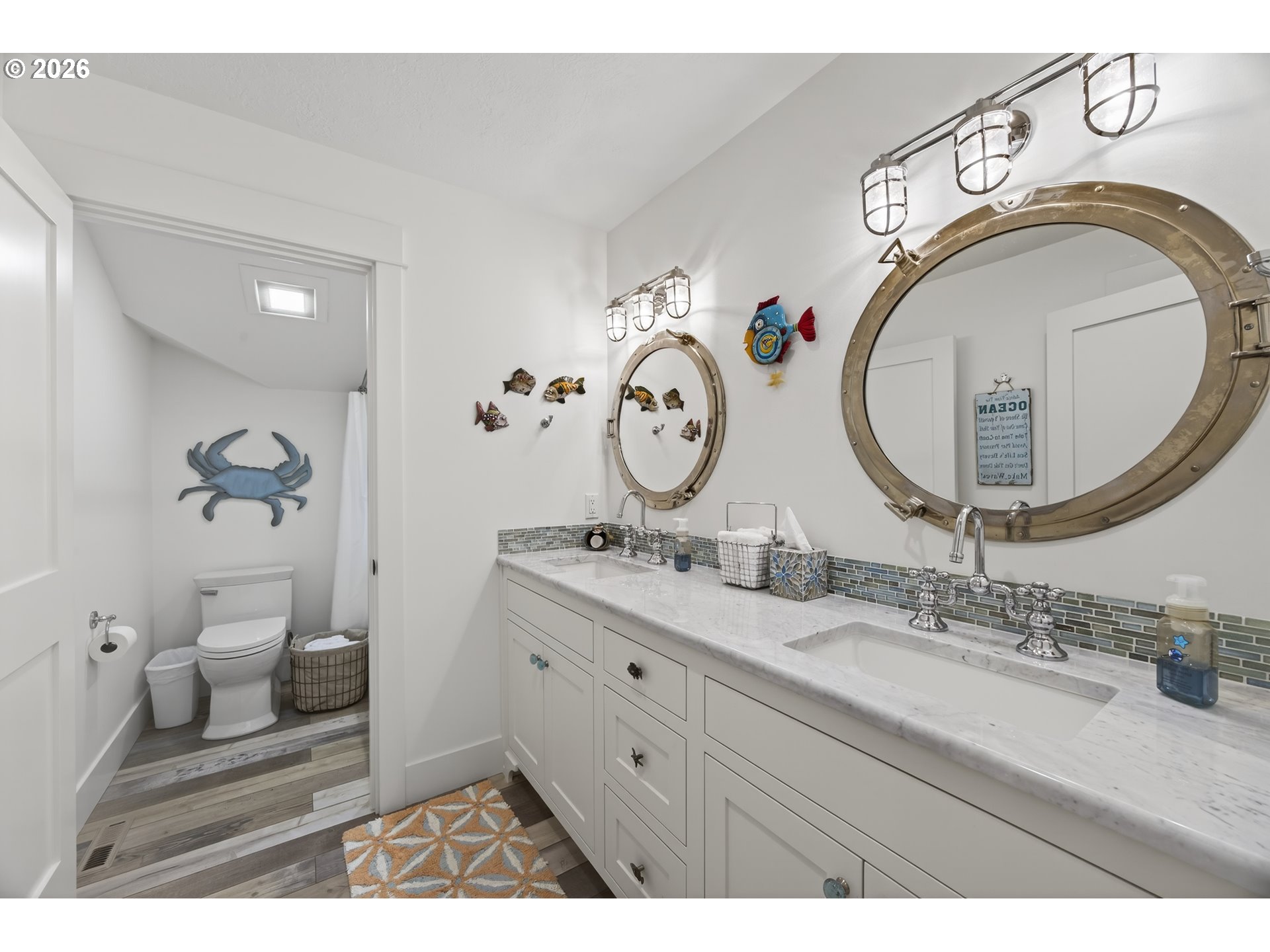 525 Point Avenue Depoe Bay, OR 97341 - Photo 29 of 47 a bathroom with a granite countertop toilet a sink and a mirror