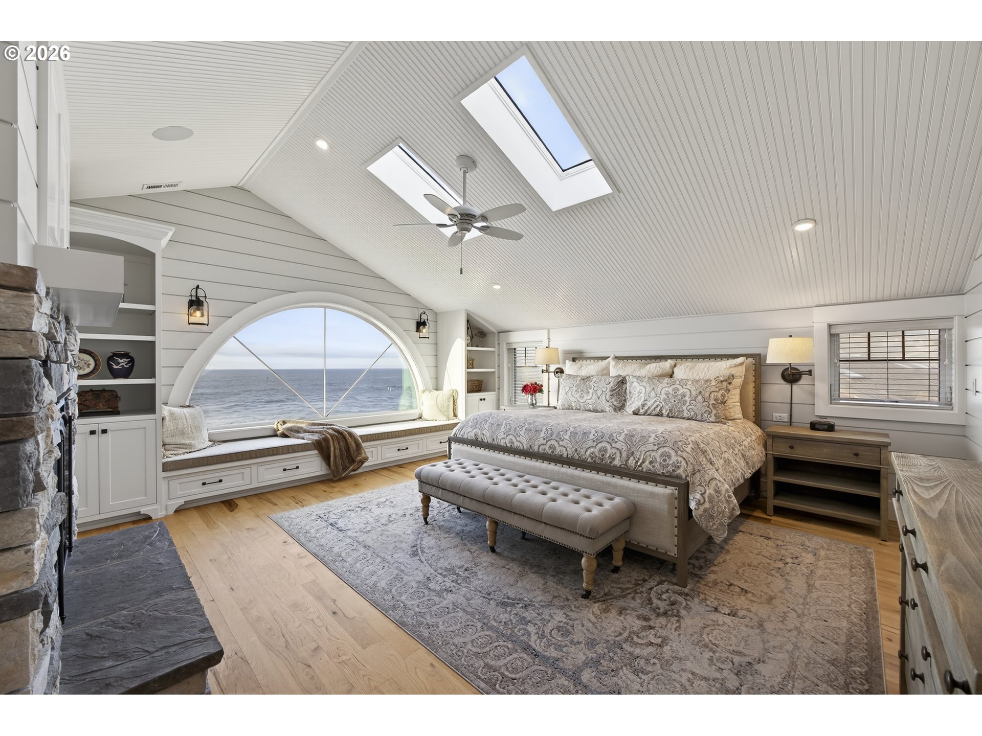 525 Point Avenue Depoe Bay, OR 97341 - Photo 34 of 47 a spacious bedroom with a bed a table and a large window