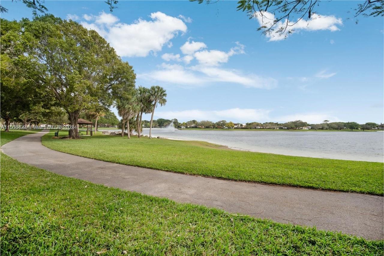 9701 Hammocks Boulevard, Unit 108A Miami, FL 33196 - Photo 3 of 8 a view of a lake with a big yard
