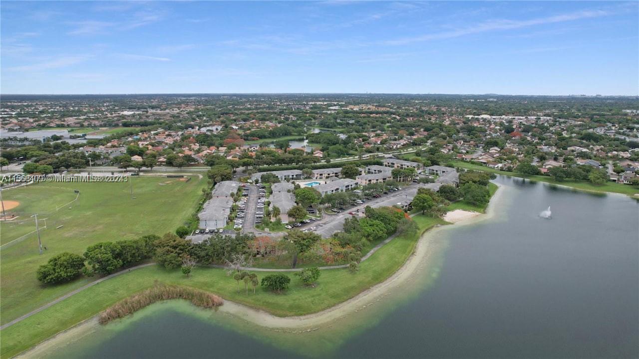 9701 Hammocks Boulevard, Unit 108A Miami, FL 33196 - Photo 8 of 8 an aerial view of a houses with a lake view