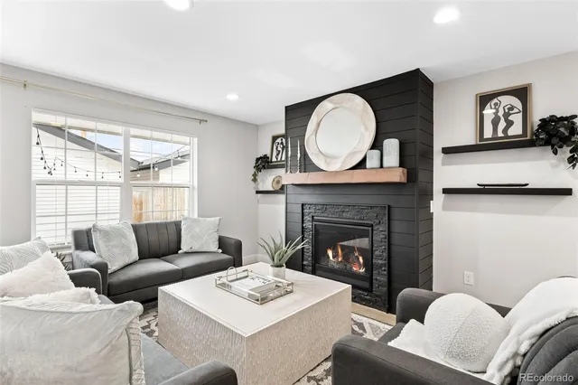 a living room with furniture a fireplace and window