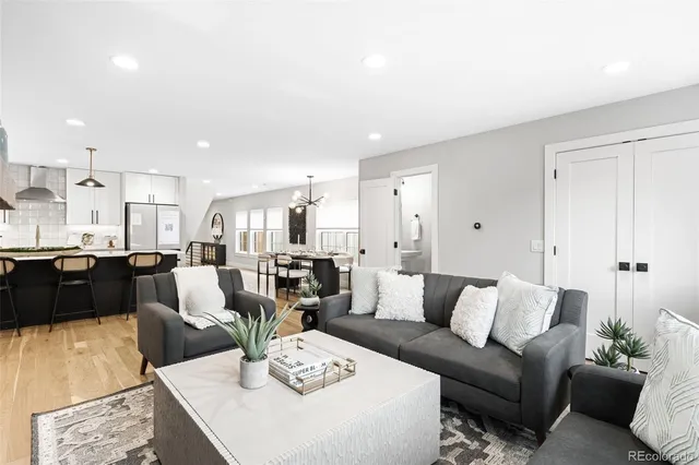 a living room with furniture kitchen view and a table