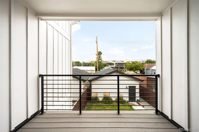 a view of a balcony with floor to ceiling windows and yard