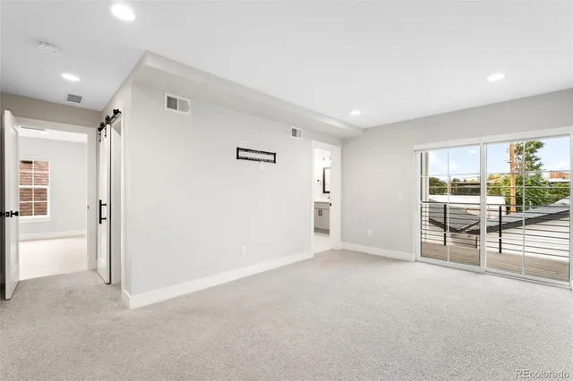 a view of a livingroom with wooden floor and furniture
