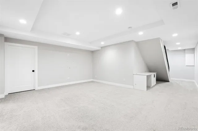 an empty room with a projector and a refrigerator