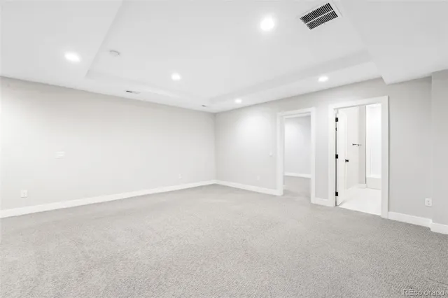 an empty room with a ceiling fan and window