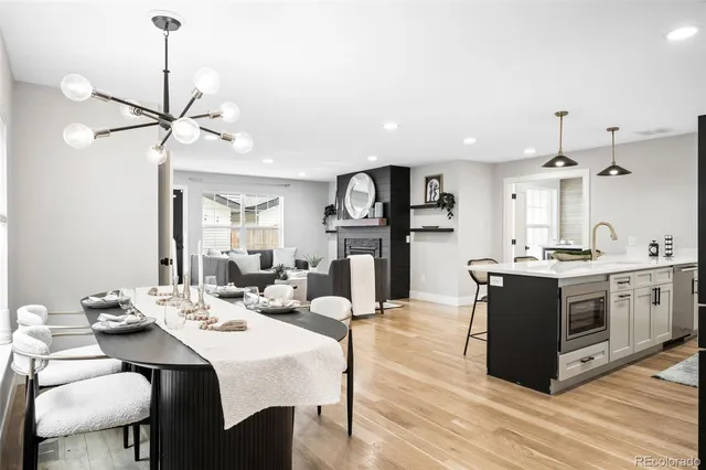 a kitchen with stainless steel appliances kitchen island a dining table and chairs