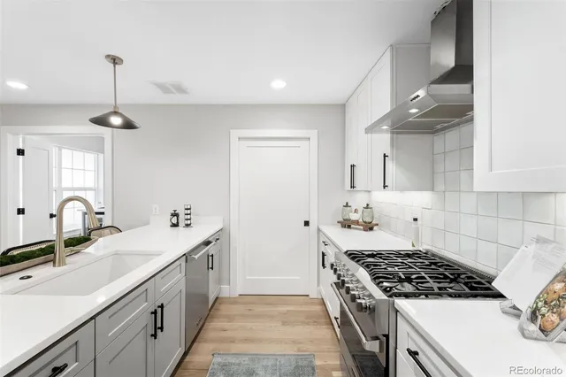 a kitchen with a sink stove and cabinets
