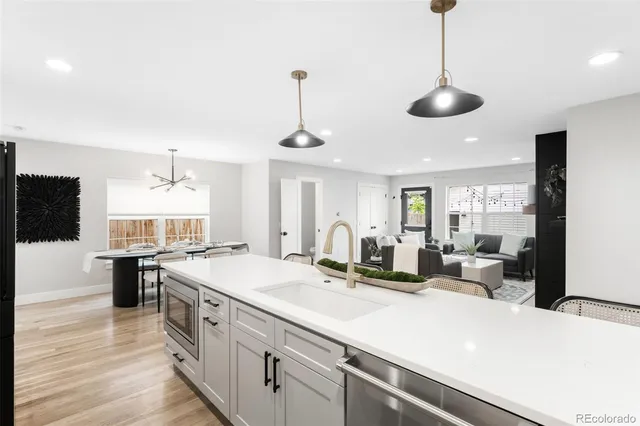 a kitchen with sink stove and refrigerator