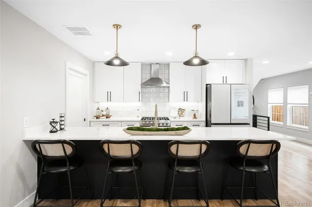 a dining room with furniture a chandelier and wooden floor