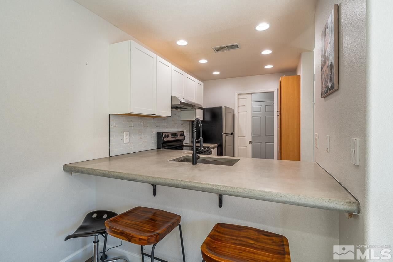 326 East 7th Street Reno, NV 89512 - Photo 3 of 21 a kitchen with a refrigerator a sink and a stove