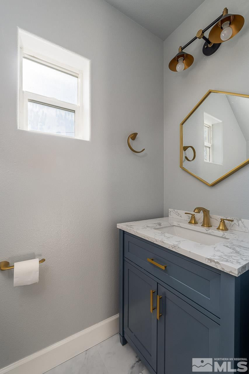 326 East 7th Street Reno, NV 89512 - Photo 5 of 21 a bathroom with a granite countertop sink vanity and a mirror