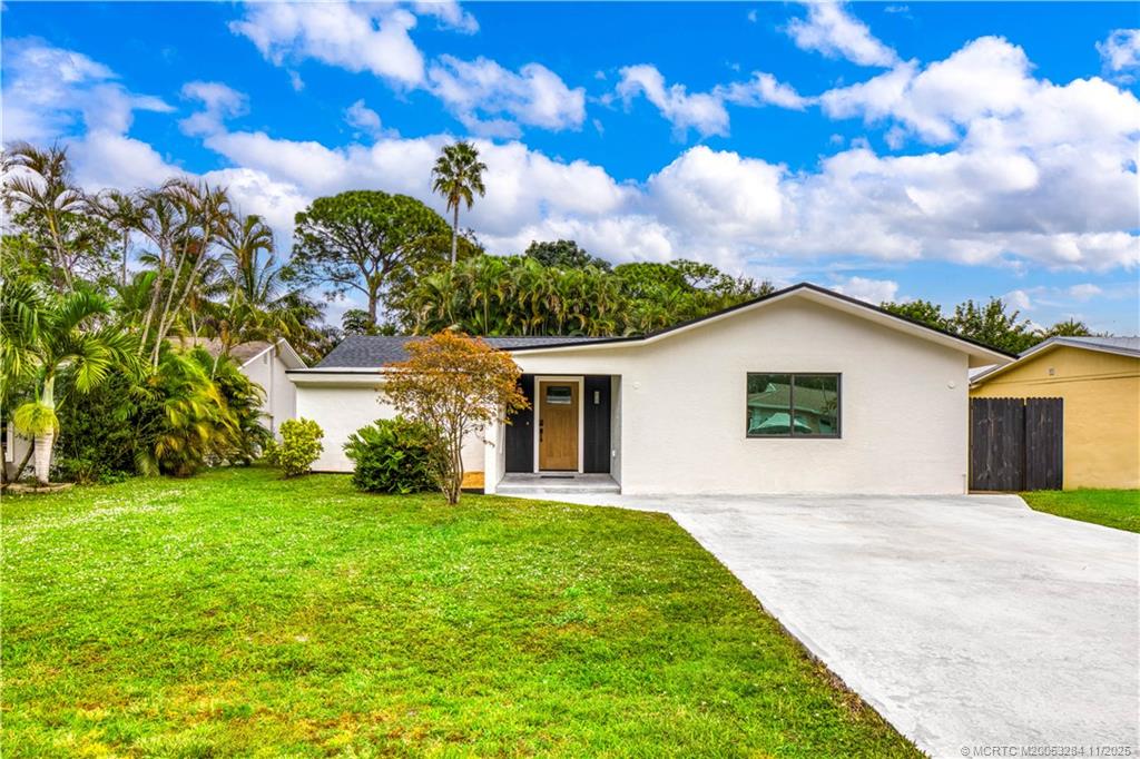5549 Southeast Normandy Avenue Stuart, FL 34997 - Photo 1 of 21 a view of a house with a yard