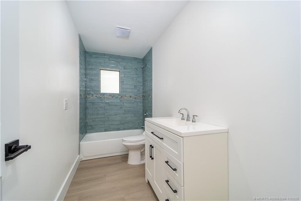 5549 Southeast Normandy Avenue Stuart, FL 34997 - Photo 15 of 21 a bathroom with a sink toilet and shower
