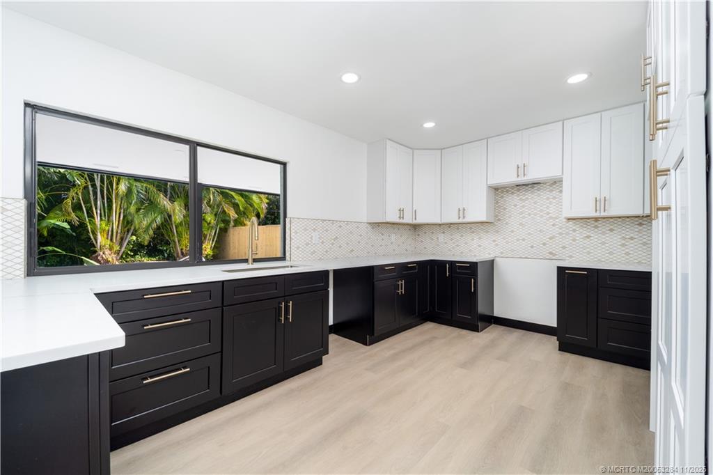 5549 Southeast Normandy Avenue Stuart, FL 34997 - Photo 8 of 21 a kitchen with a sink and a large window