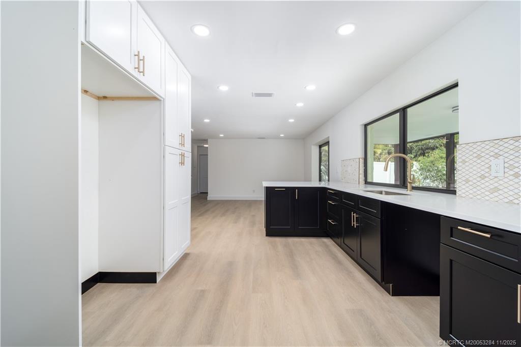 5549 Southeast Normandy Avenue Stuart, FL 34997 - Photo 9 of 21 a large bathroom with a double vanity and a window