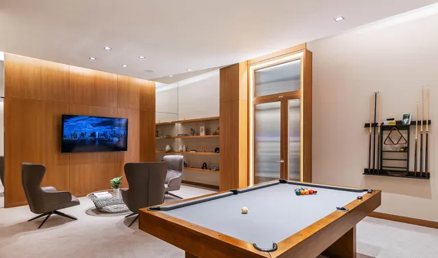 a room with furniture pool table and windows