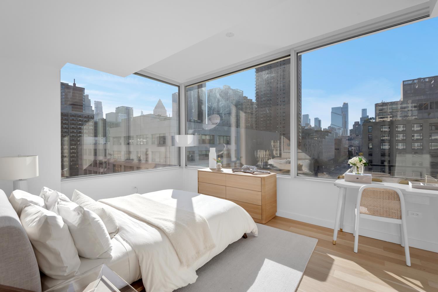 611 West 56th Street, Unit 3A Manhattan, NY 10019 - Photo 5 of 23 a bedroom with a large bed and a balcony view