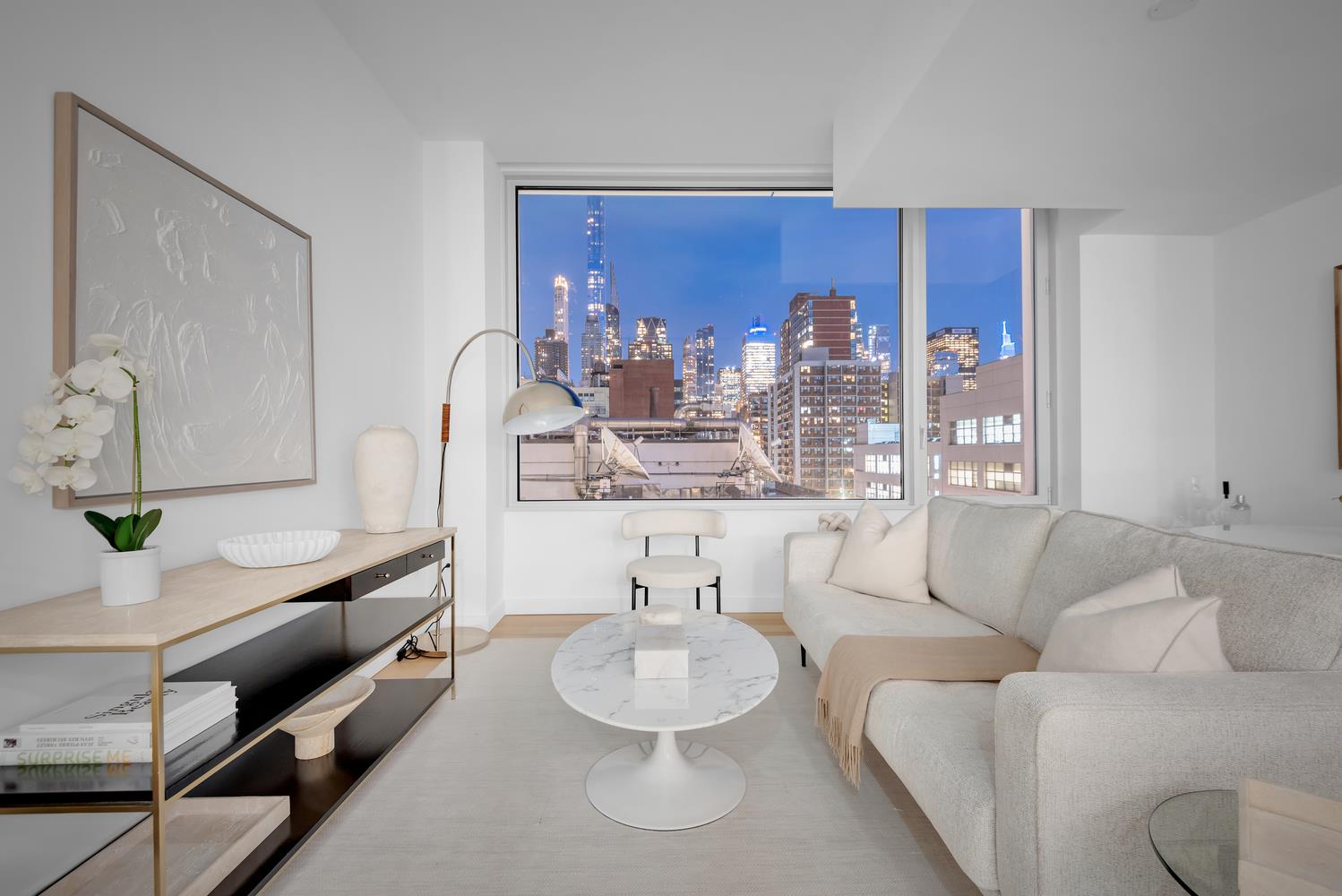 611 West 56th Street, Unit 3A Manhattan, NY 10019 - Photo 6 of 23 a living room with furniture and a large window