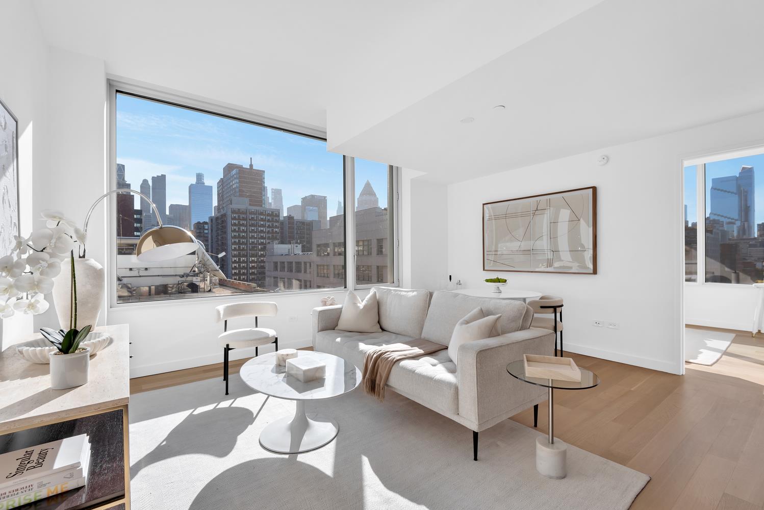 611 West 56th Street, Unit 3A Manhattan, NY 10019 - Photo 7 of 23 a living room with furniture and a large window
