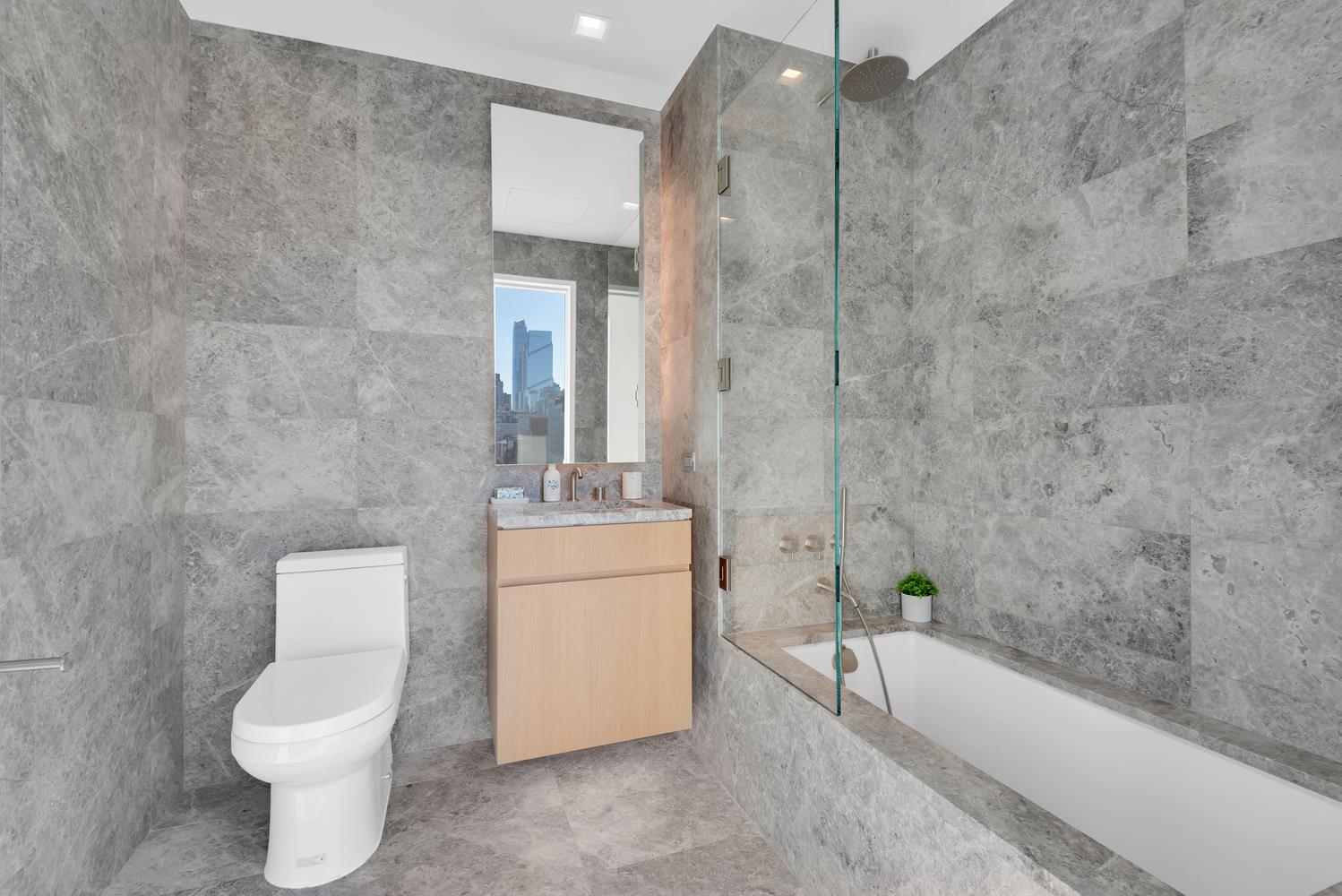 611 West 56th Street, Unit 3A Manhattan, NY 10019 - Photo 8 of 23 a bathroom with a toilet a sink and bathtub