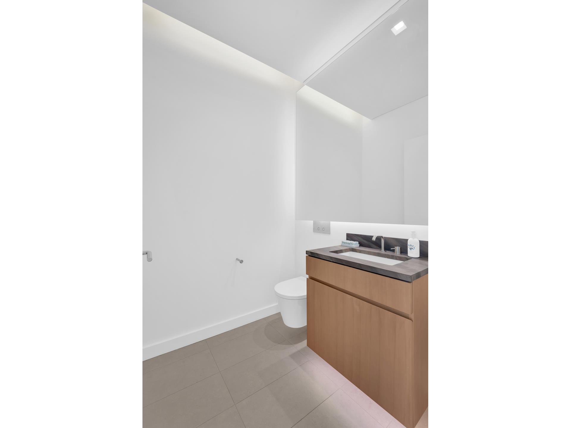 611 West 56th Street, Unit 3A Manhattan, NY 10019 - Photo 9 of 23 a kitchen with a stove and a refrigerator