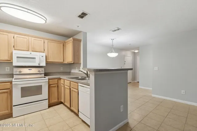 a kitchen with cabinets appliances and a sink